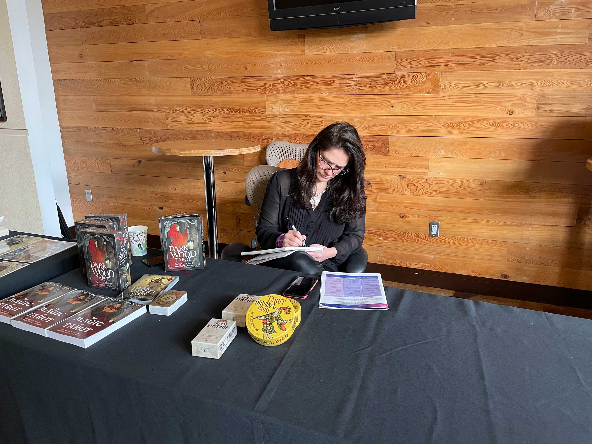 Headliner Sasha Graham signs her book at StaarCon 2022.